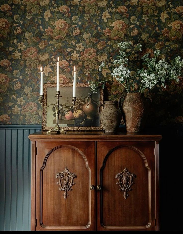 Floral wallpaper with candles, greenery, and decorative vases