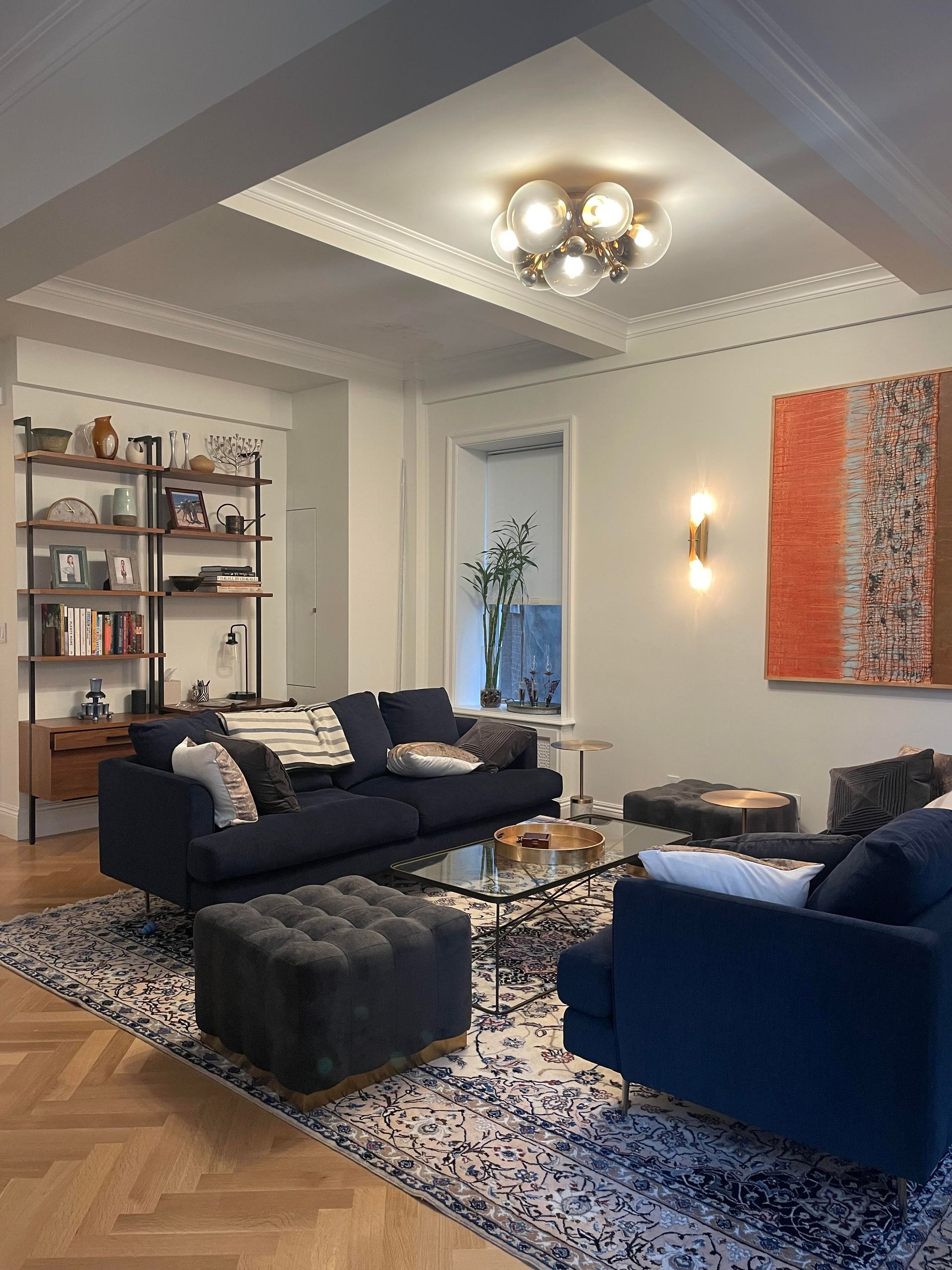 Living room ceiling detail with crown molding, chandelier, shelving, and framed artwork , Sofa seating arrangment 