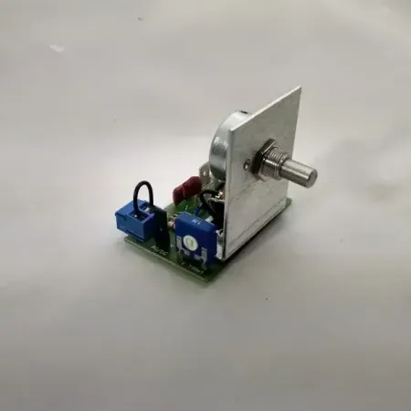 A small electronic device is sitting on a white surface.