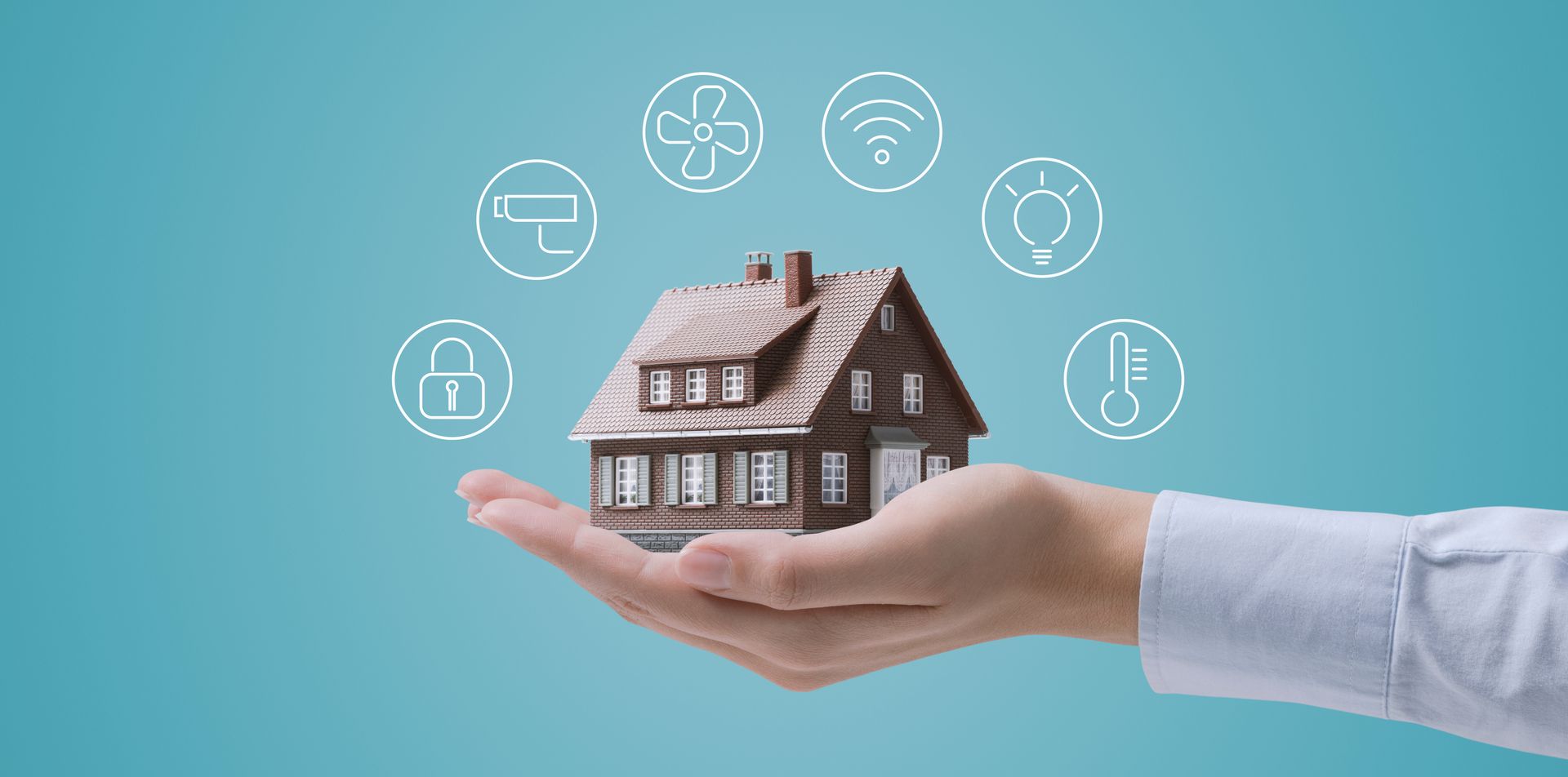 Hand holding a model home surrounded by smart home technology icons.