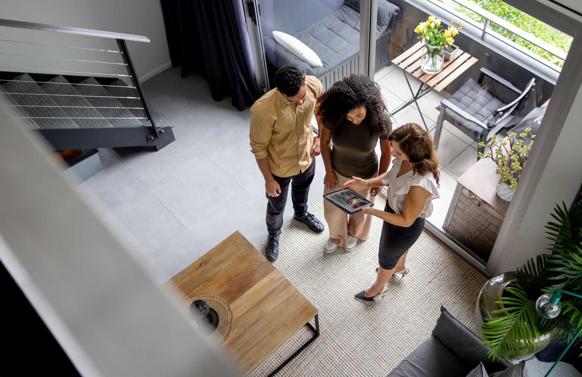 Couple discussing details of a house with their real estate agent.