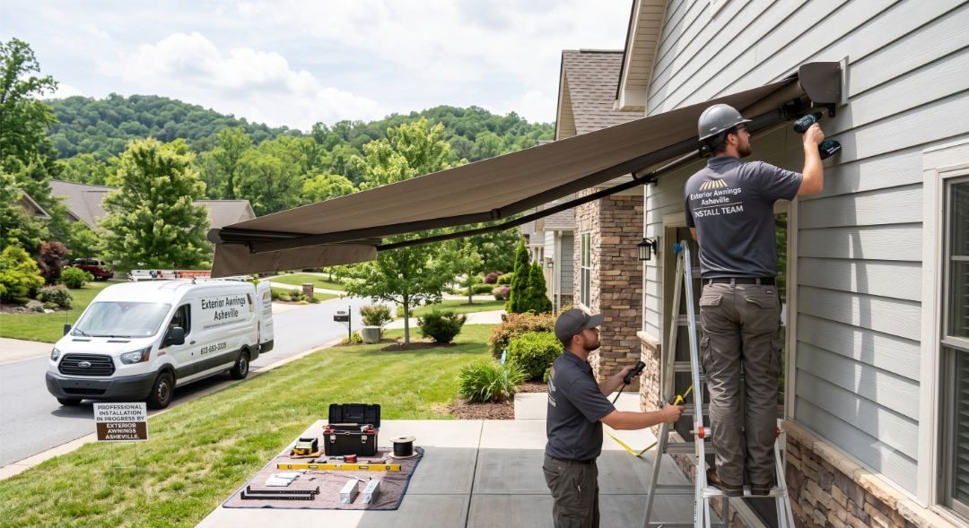 Installers mounting a retractable awning housing to a home's wall, illustrating an Exterior Awnings Asheville install in Flat Rock near Hendersonville, NC