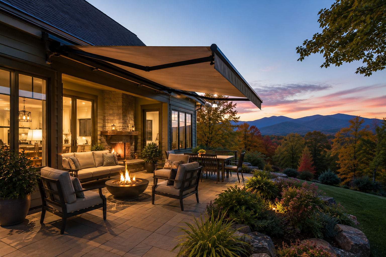 Cozy patio with exterior awning, fire pit and outdoor seating overlooking mountains at sunset