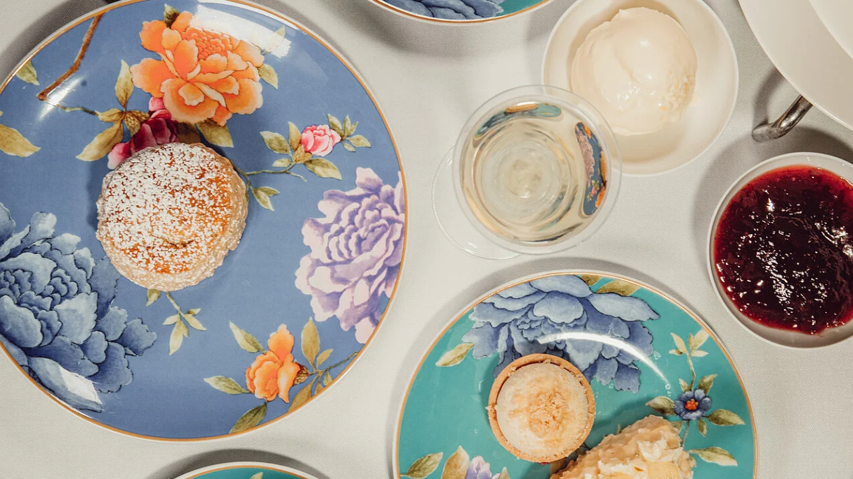 A photo of afternoon British Tea with delicious and beautiful little cakes and sandwiches