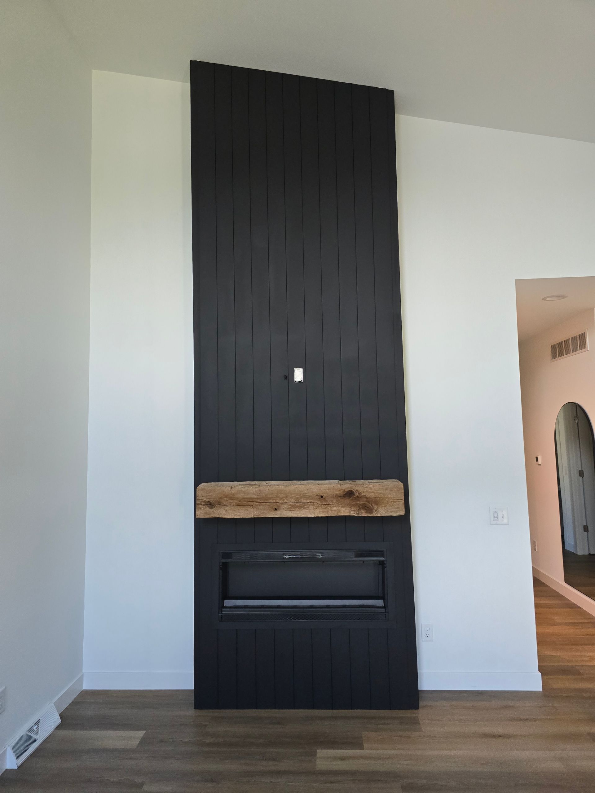 There is a fireplace in the corner of the room.