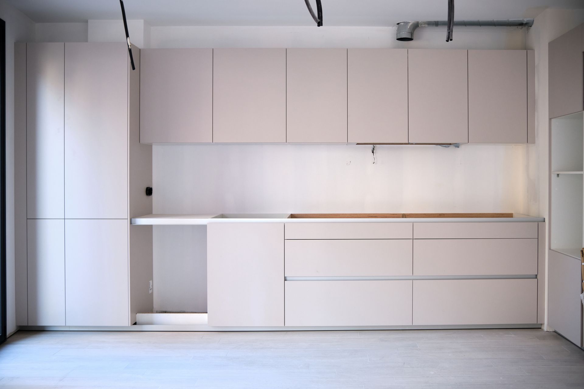 An Empty Kitchen with White Cabinets and Drawers — Inverness, FL — First Class Refinishing