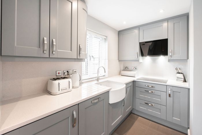 A Kitchen with Gray Cabinets and White Counter Tops — Inverness, FL — First Class Refinishing 