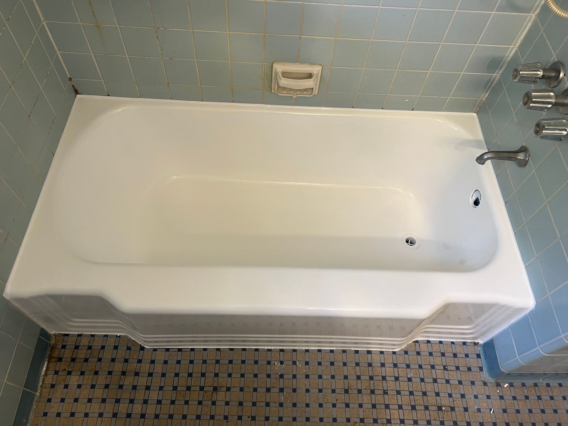 A White Bathtub in A Bathroom with Blue Tiles — Inverness, FL — First Class Refinishing 