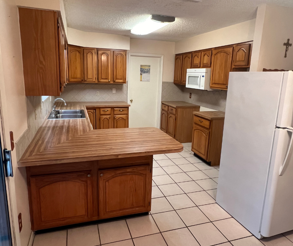 A Kitchen with Wooden Cabinets and A White Refrigerator — Inverness, FL — First Class Refinishing 