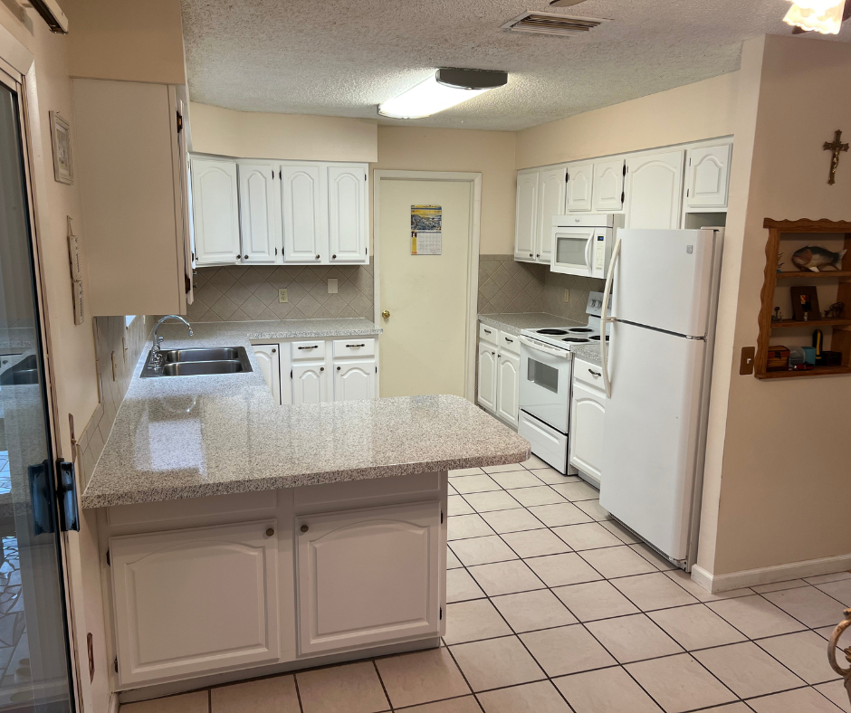 A Kitchen with White Cabinets and A White Refrigerator — Inverness, FL — First Class Refinishing 