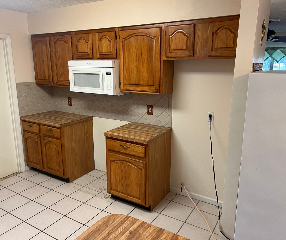 A Kitchen with Wooden Cabinets , a Microwave , and A Refrigerator — Inverness, FL — First Class Refinishing 