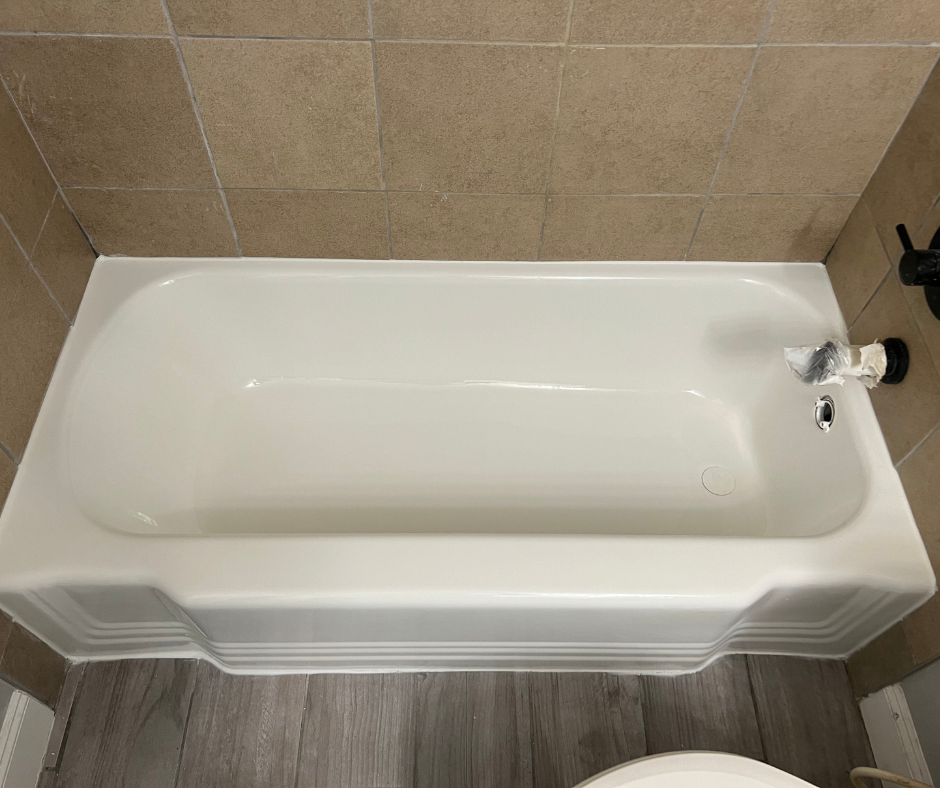 A White Bathtub Is in A Bathroom Next to A Toilet — Inverness, FL — First Class Refinishing 