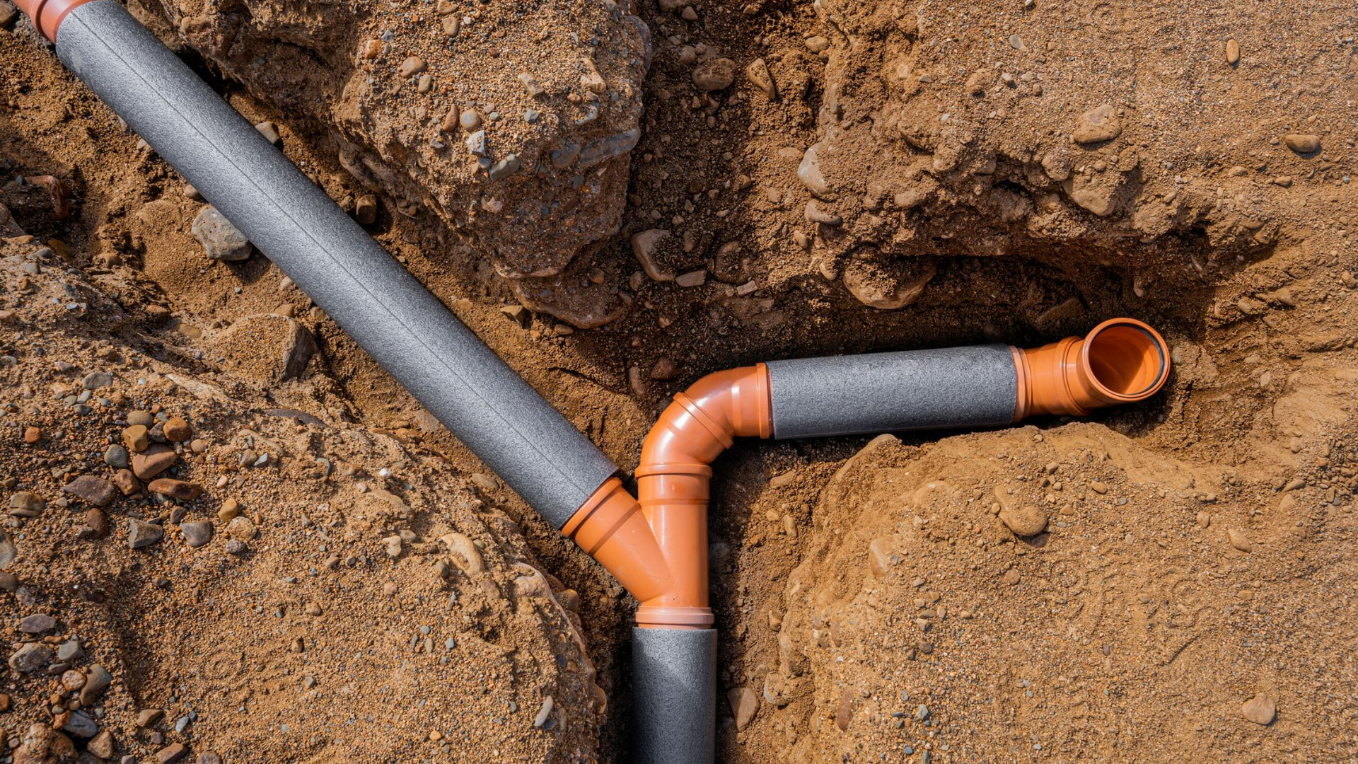 Laying of sewer pipes. Weaving several pipes into one. View from above.