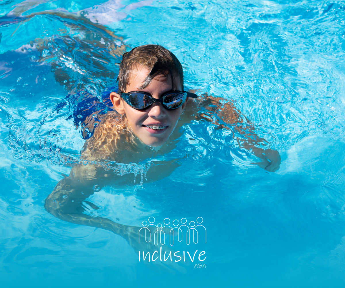 Child swimming in a bright blue pool, smiling and wearing goggles