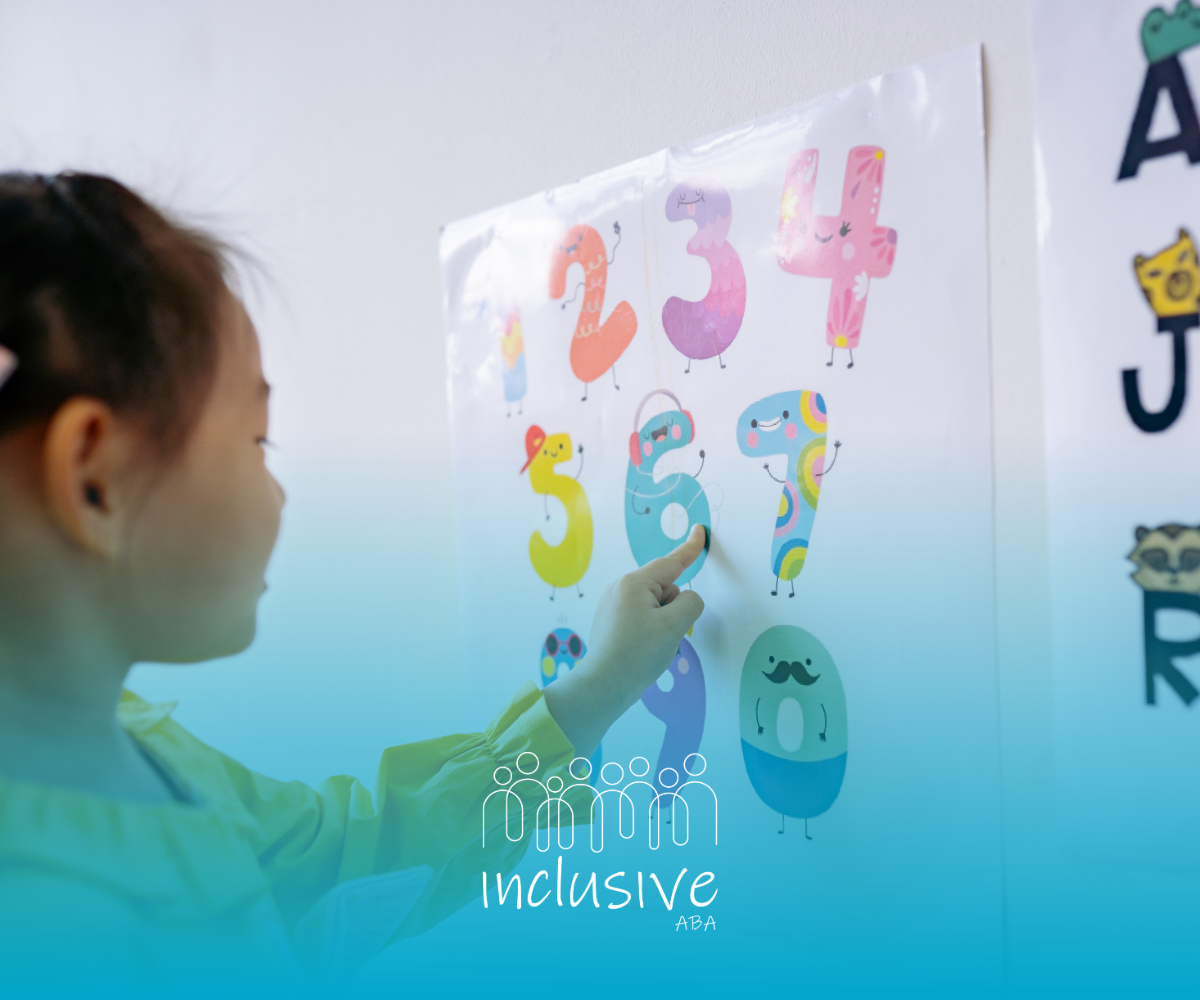 Child pointing at colorful numbers on a classroom wall poster