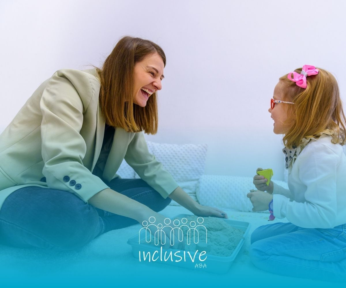 Woman smiling and talking with a child on a bed, holding a toy, in a soft blue room.
