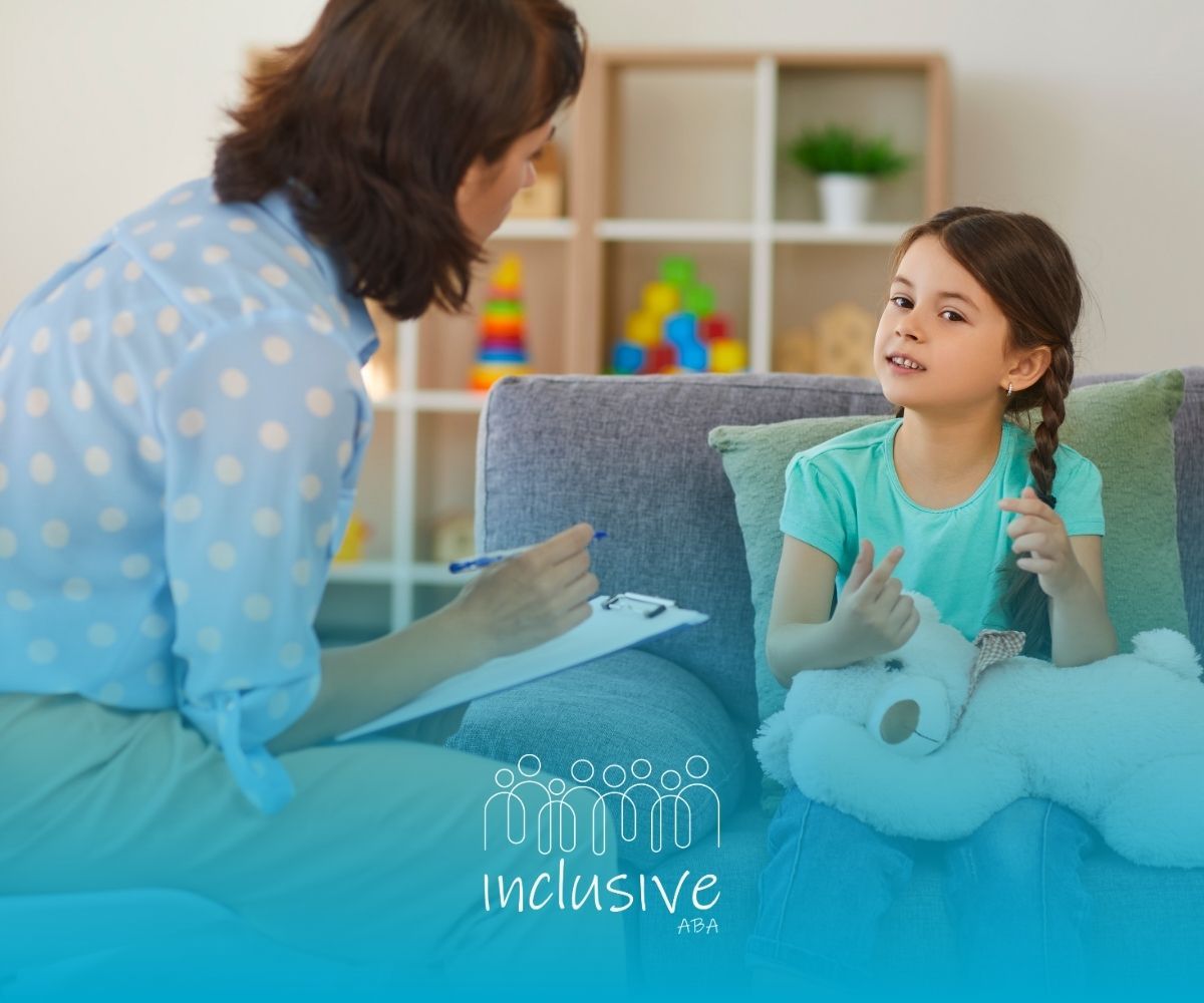 Therapist talking with a child in a cozy room, clipboard in hand, with a stuffed bunny nearby.
