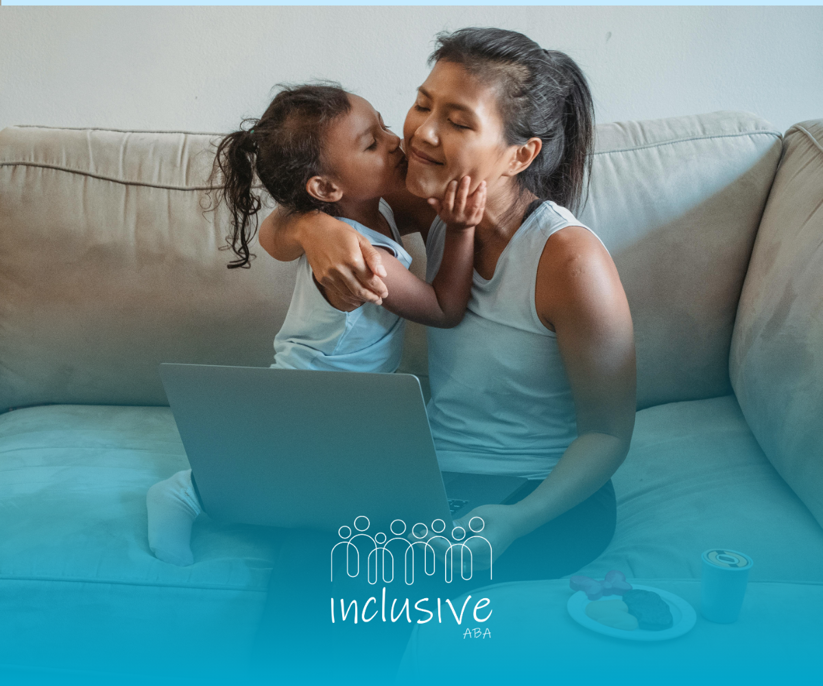 Adult and child sharing a hug on a couch, with a laptop on the adult's lap and a snack tray nearby.