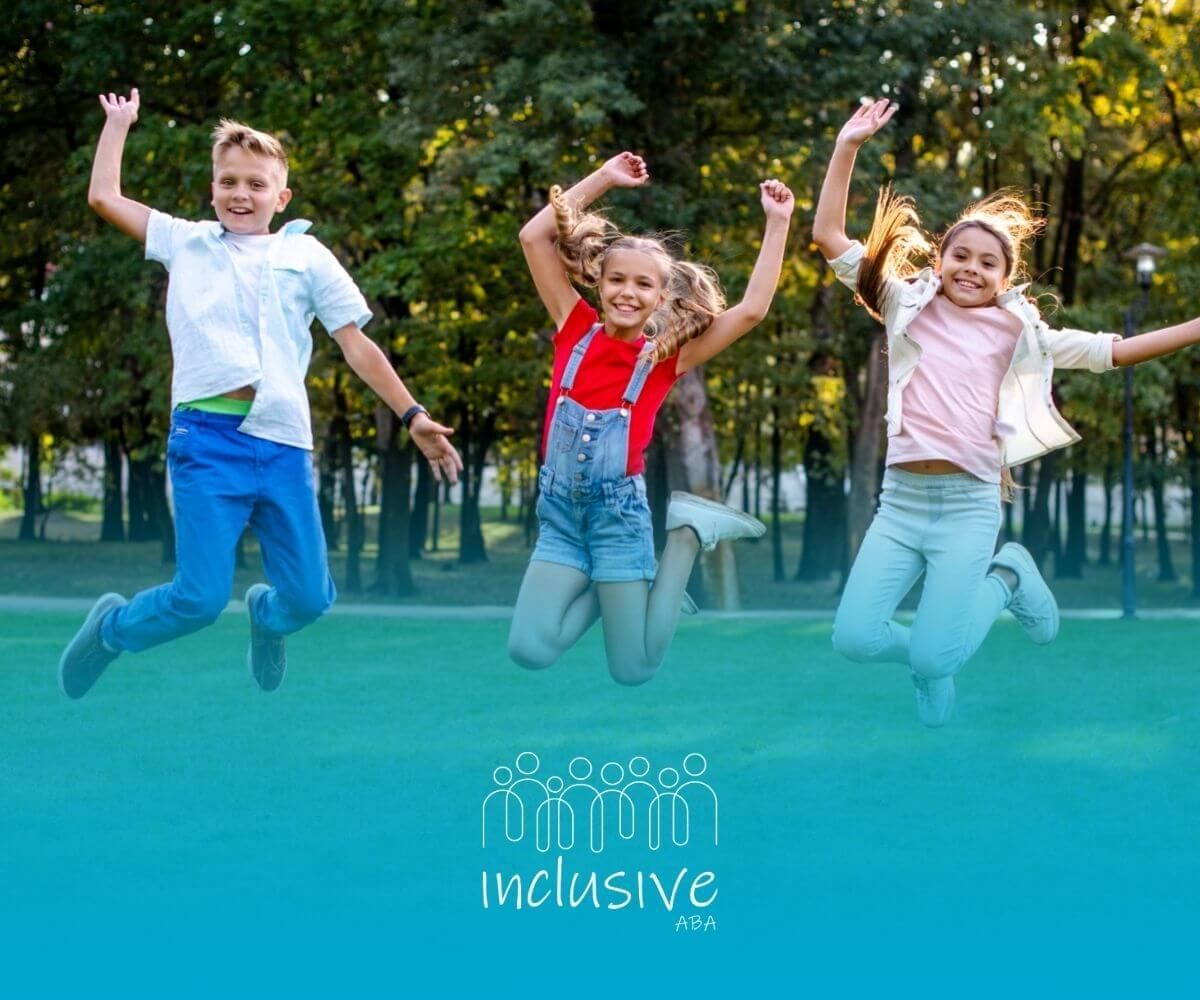Three children with autism jumping joyfully in a park.
