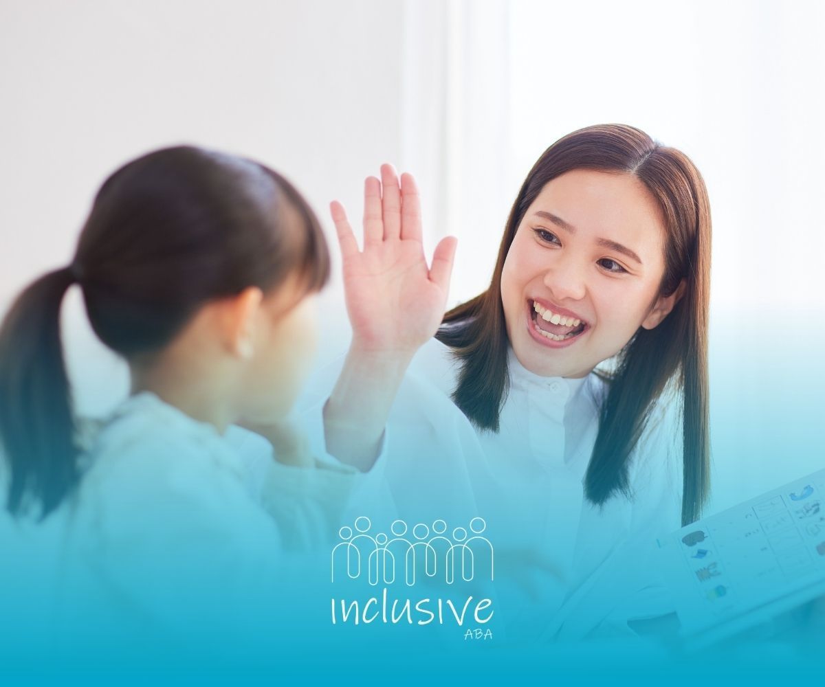 Two people smiling and high-fiving in a bright, modern setting, with “inclusive” text at the bottom.