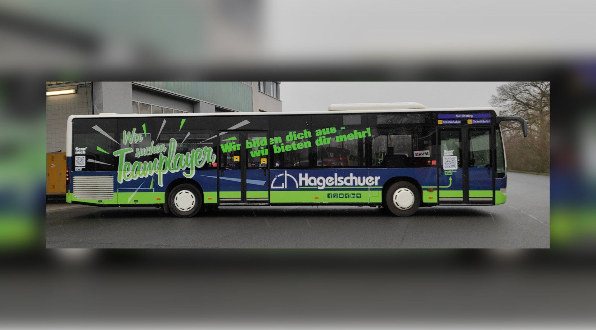 A blue and green bus is parked on the side of the road.
