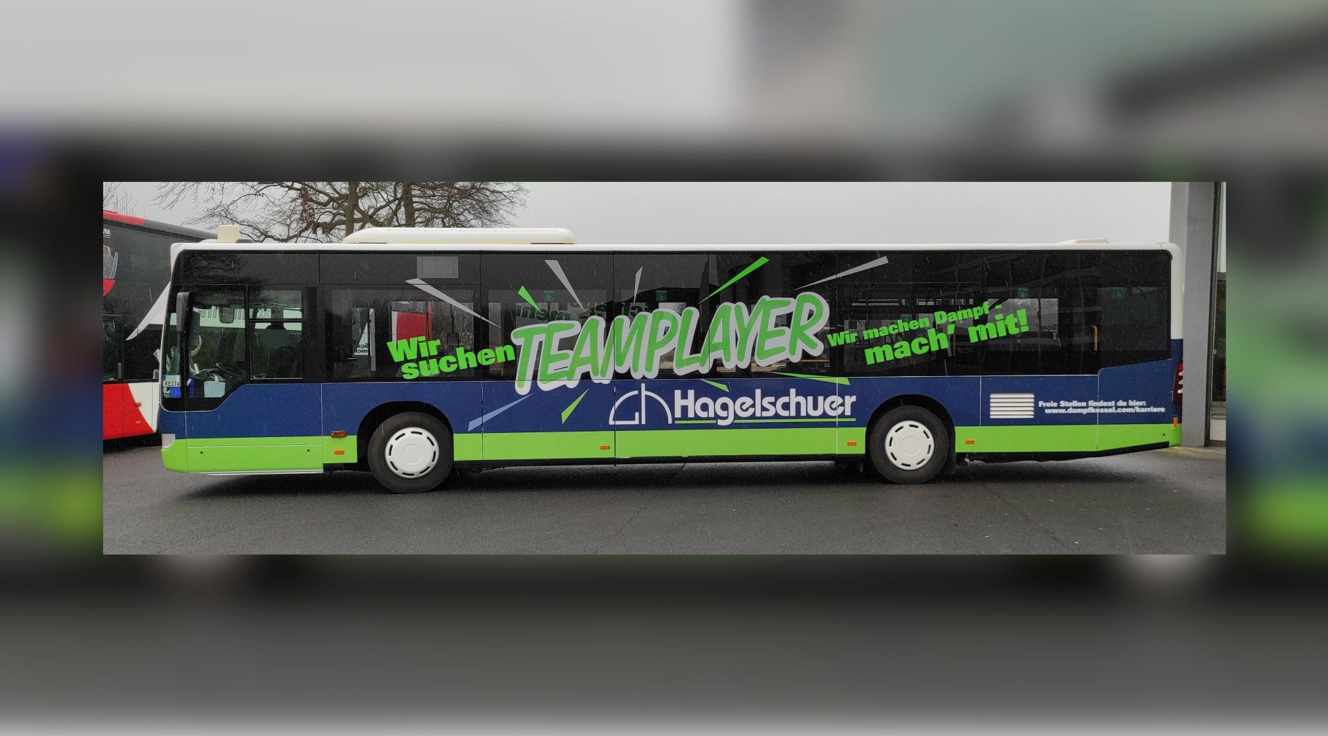 A blue and green bus with the word teamplayer on the side
