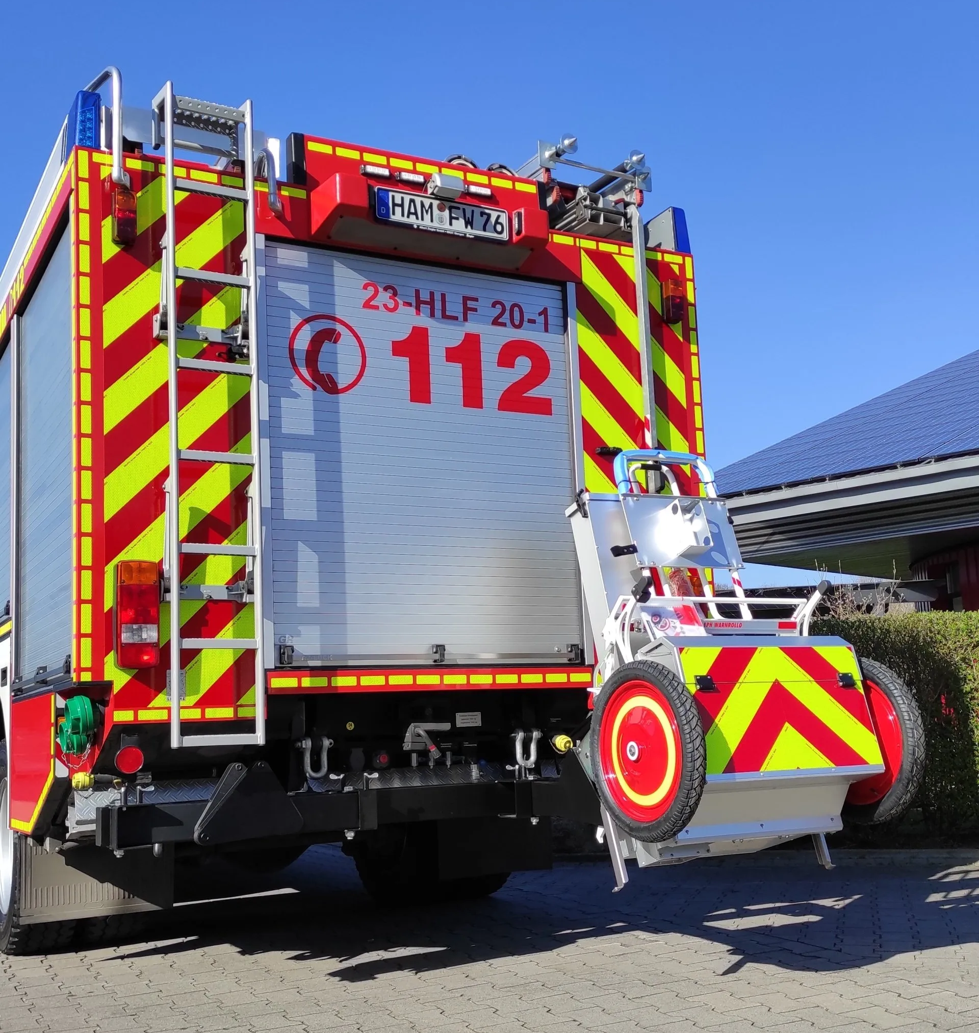 A red and yellow fire truck with the number 112 on the back