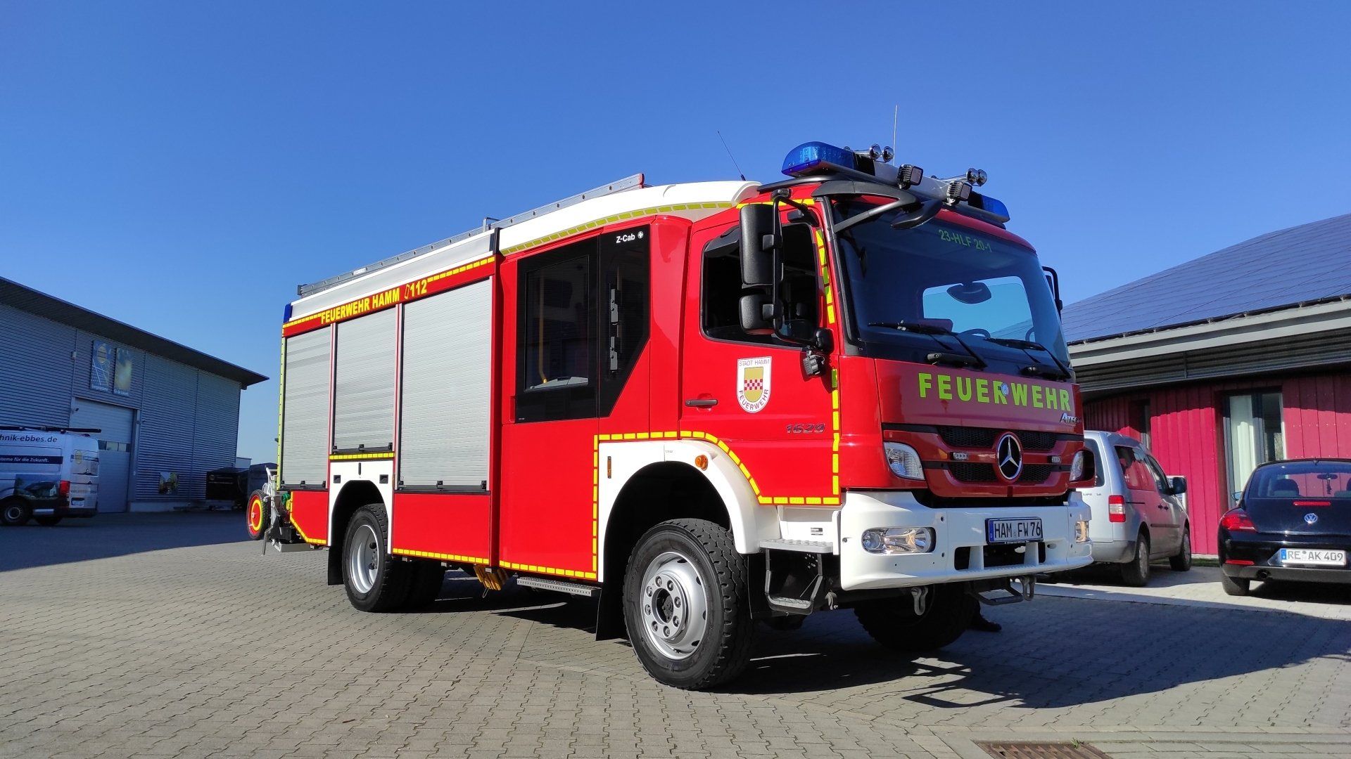 A red fire truck is parked in front of a building.