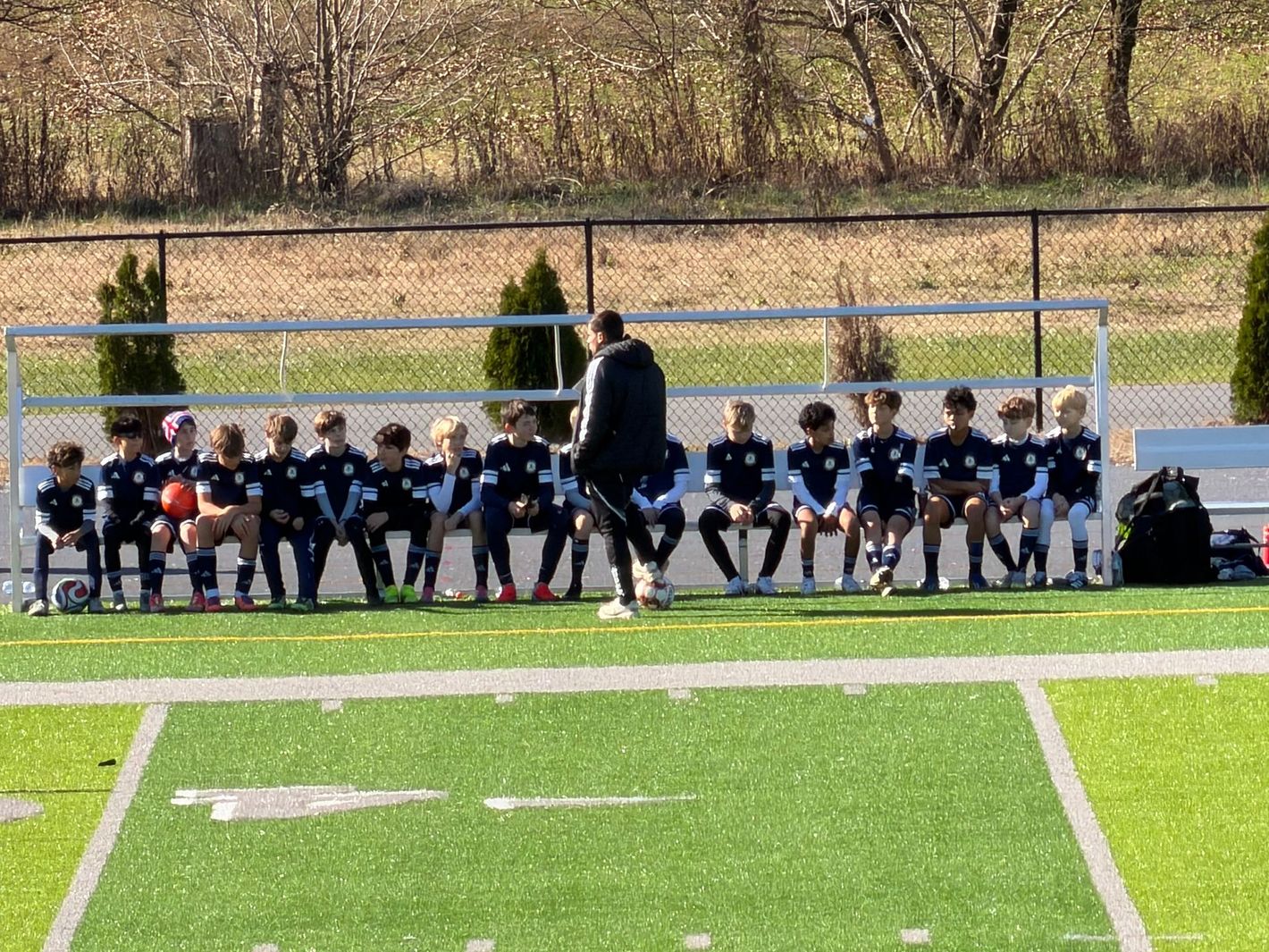 Boys sitting on soccer bench
