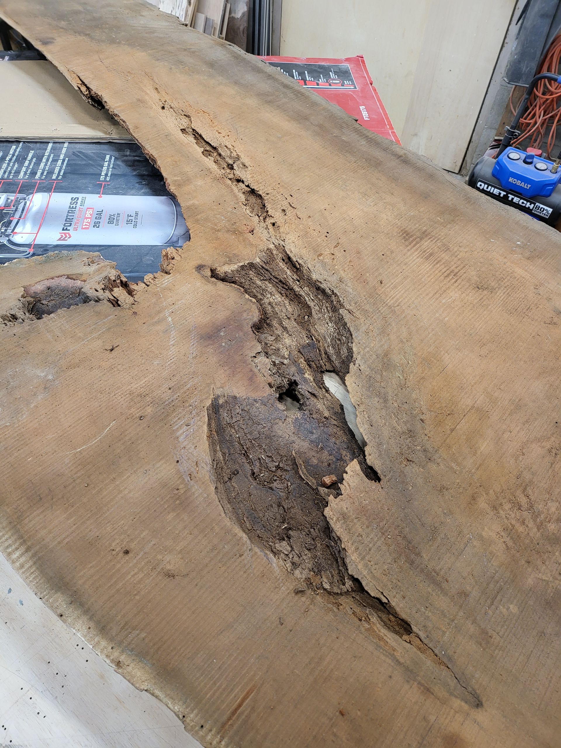 A piece of wood with a hole in it is sitting on a table.