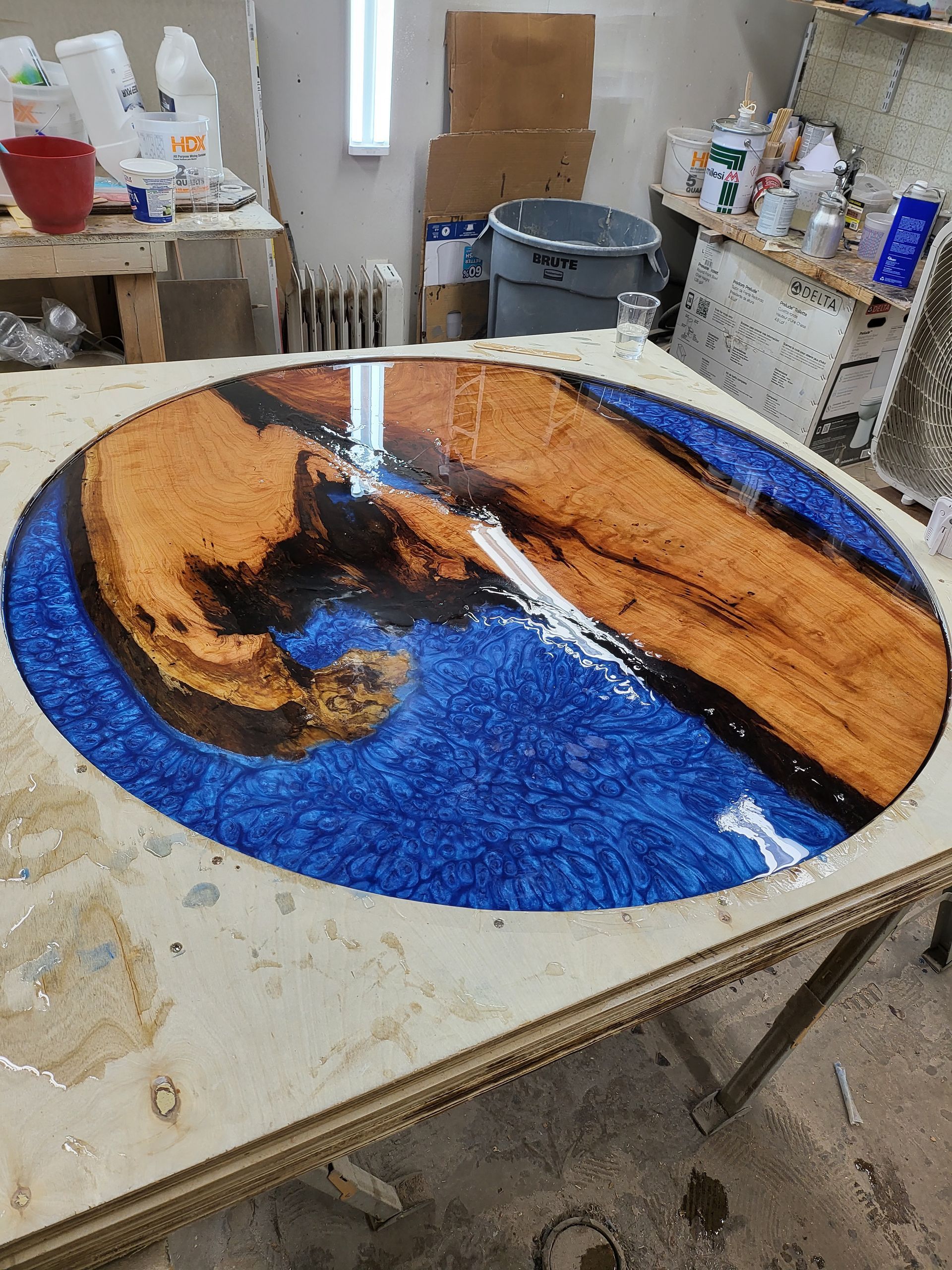 A wooden table with a blue and brown painting on it.