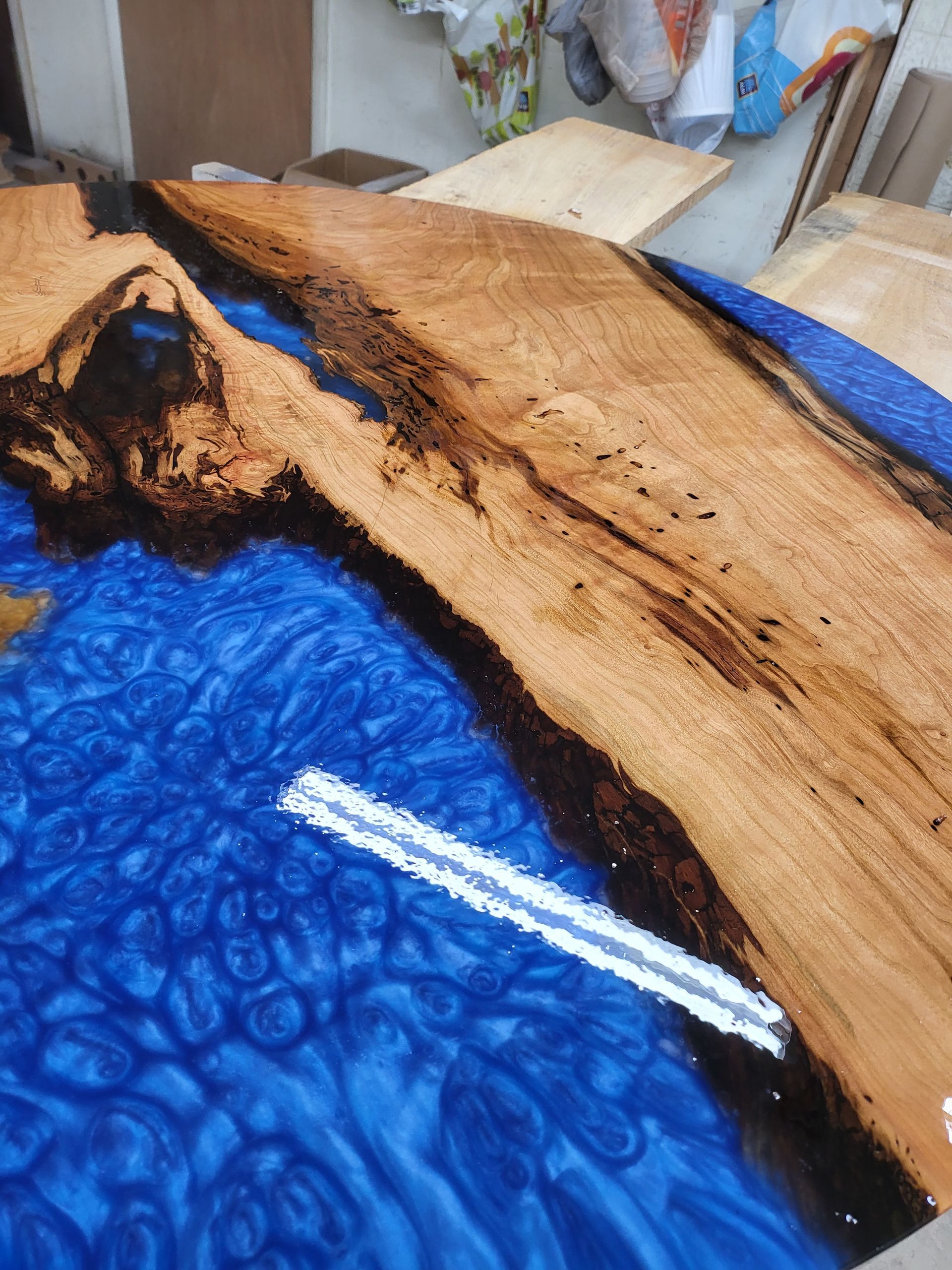 A piece of wood is sitting on top of a blue surface.