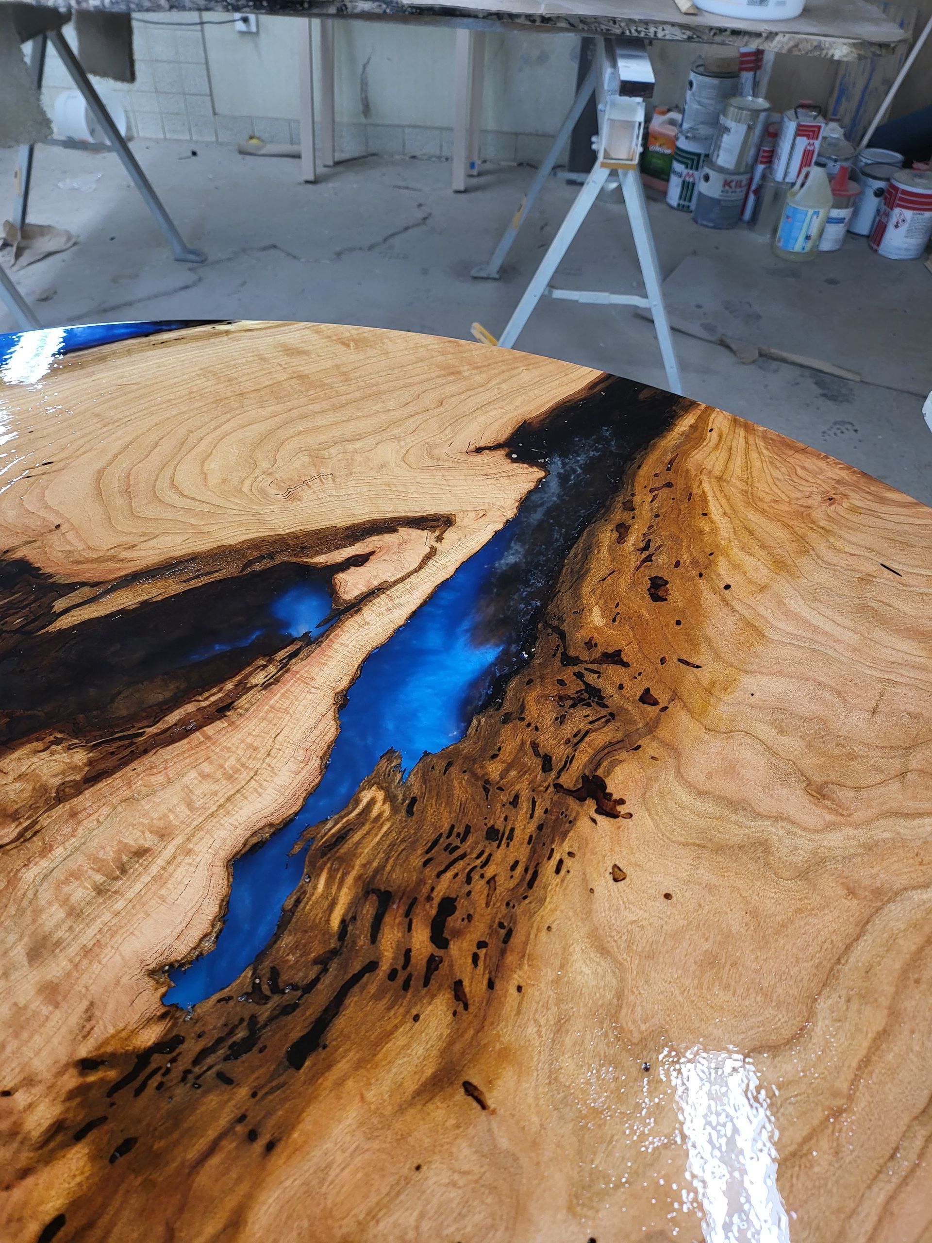 A wooden table with a blue river in the middle of it.