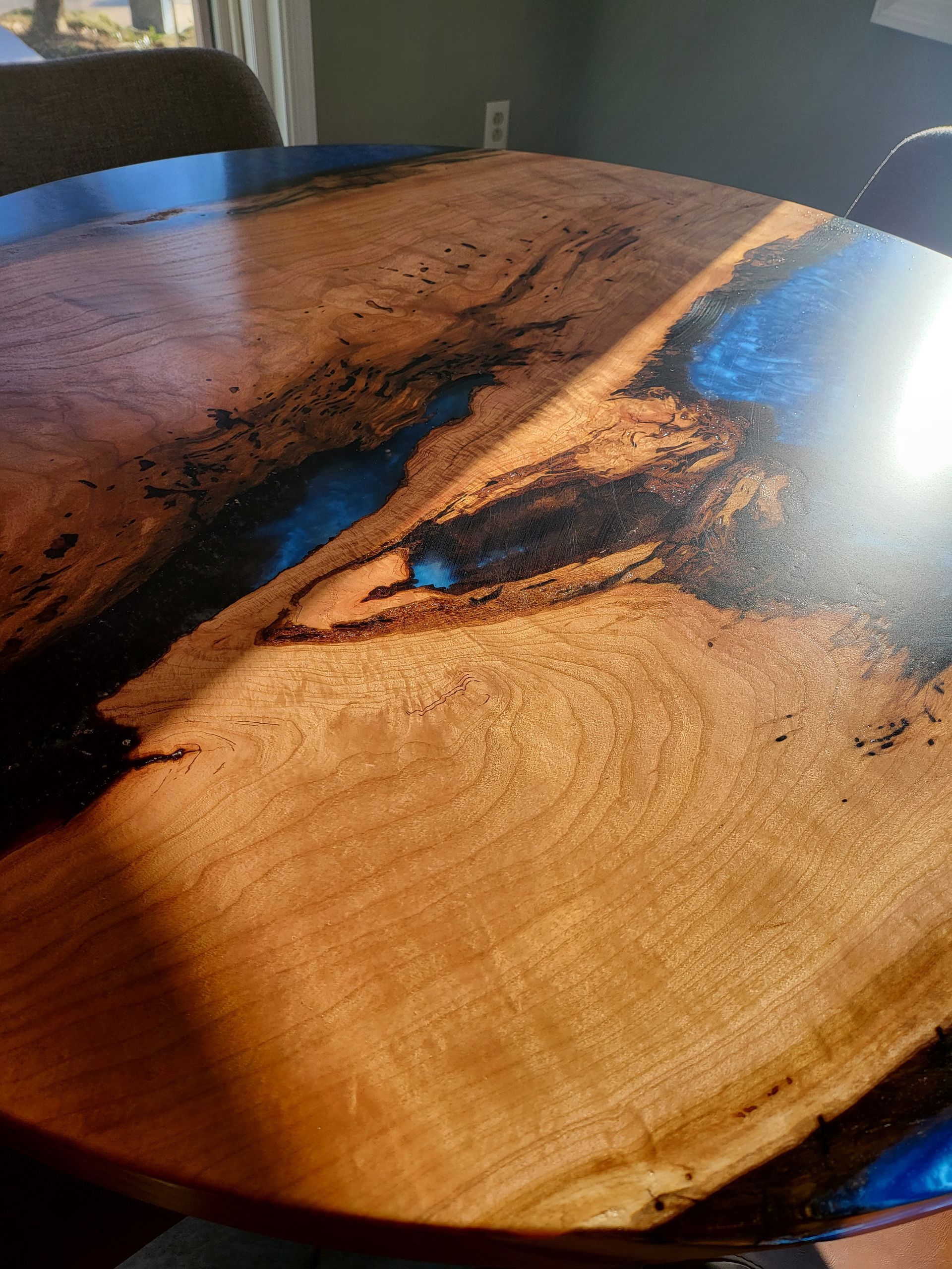A wooden table with a river in the middle of it.