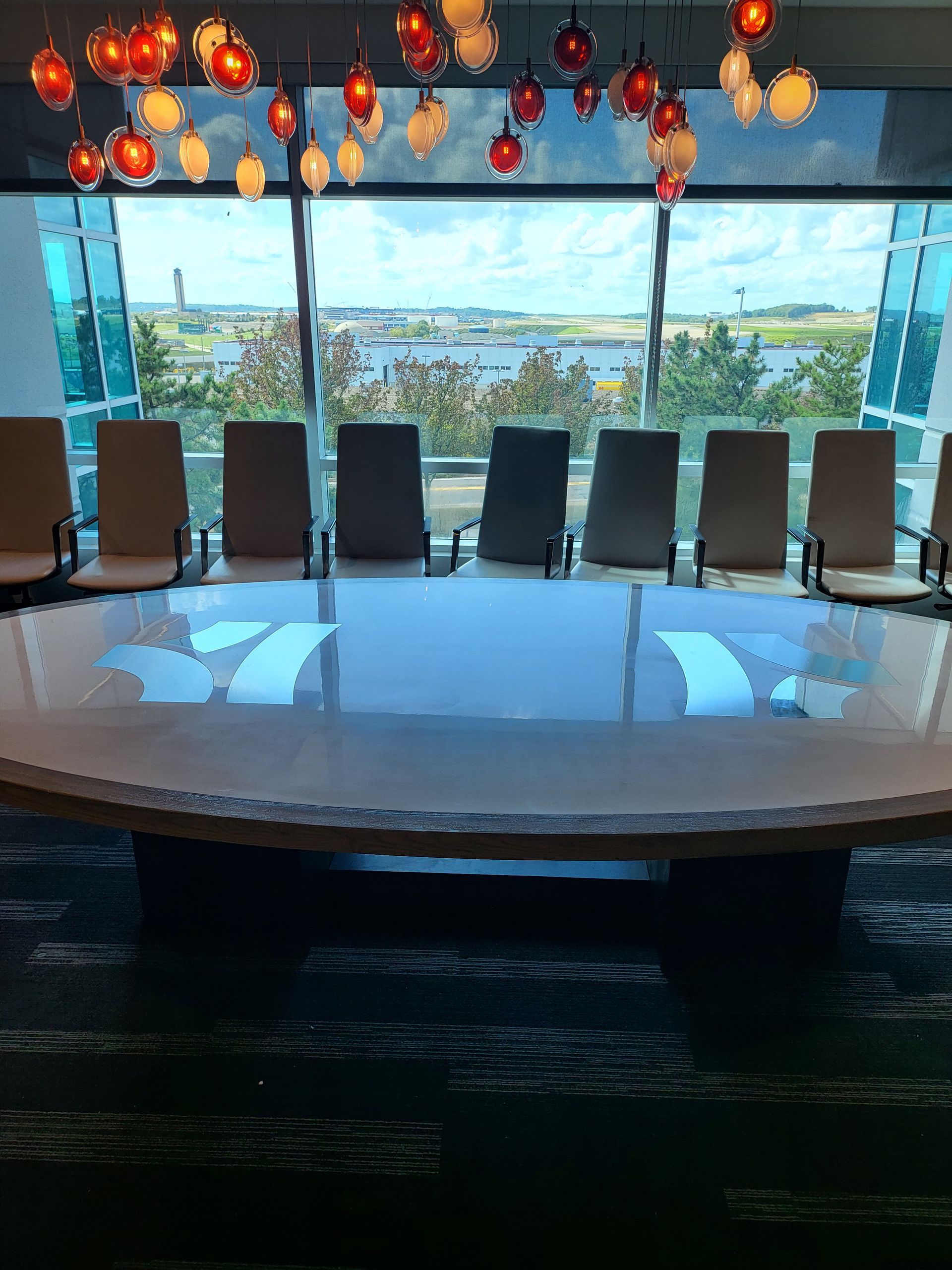 A conference room with a large round table and chairs