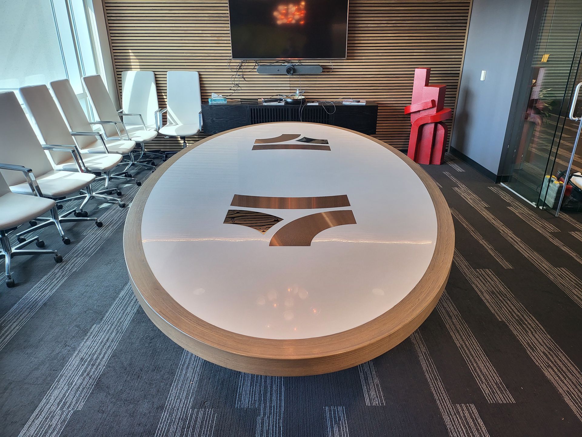 A conference room with a large round table and chairs