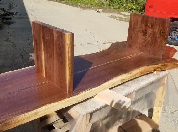 A piece of wood is sitting on top of a wooden table.