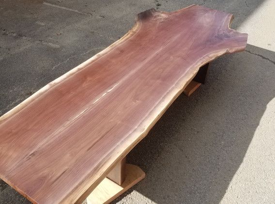 A large piece of wood is sitting on the ground.