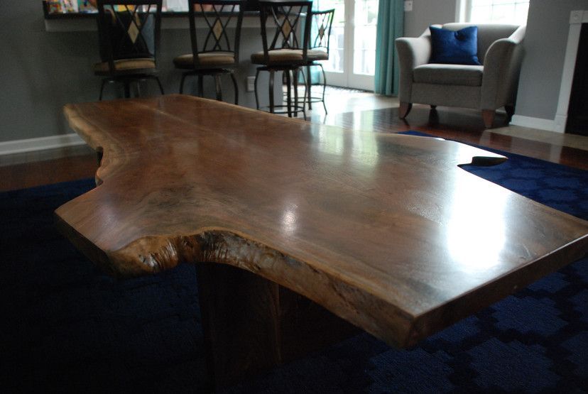 A living room with a large wooden table and chairs