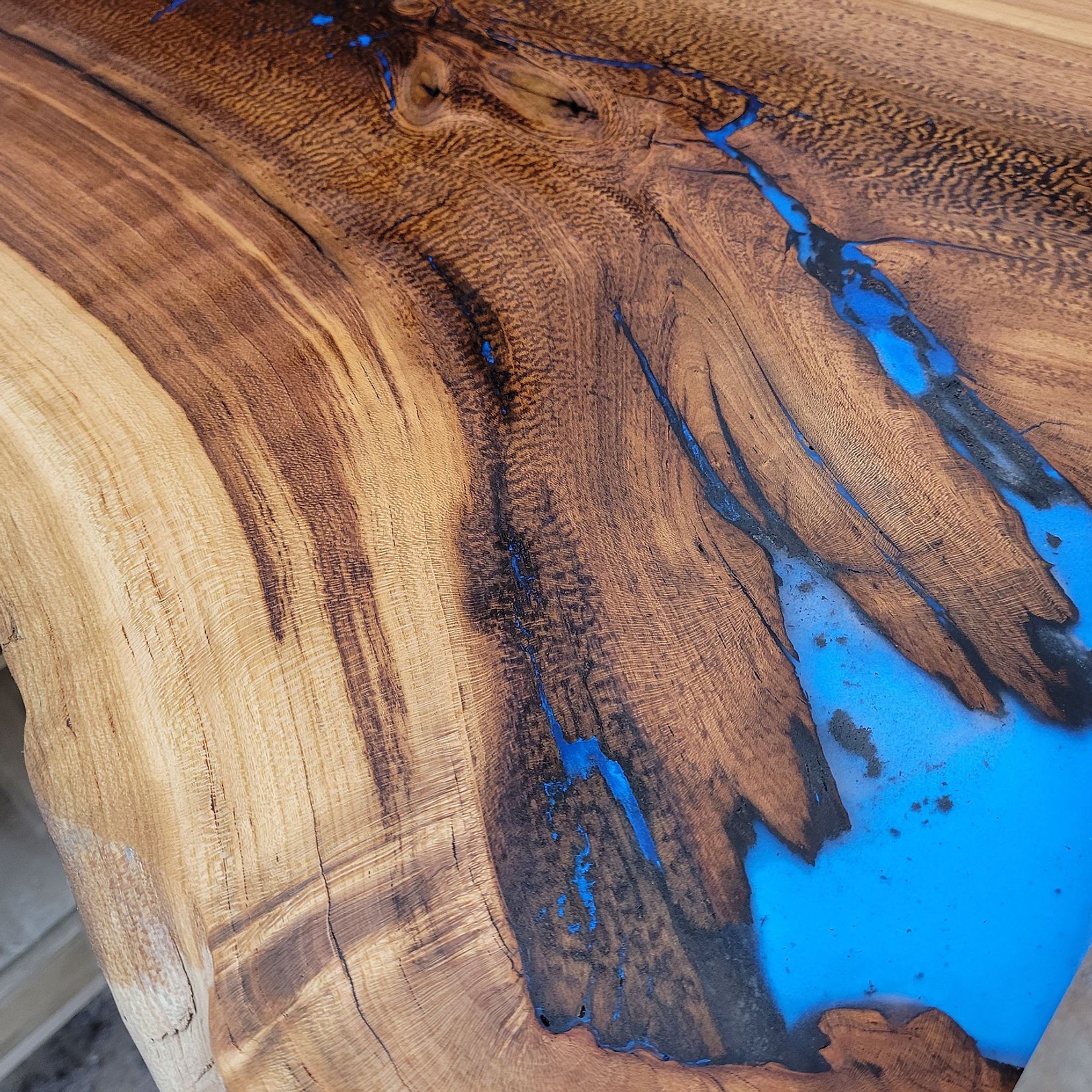 A close up of a piece of wood with blue paint on it.