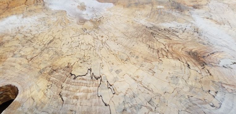 A close up of a piece of wood with a marble texture.
