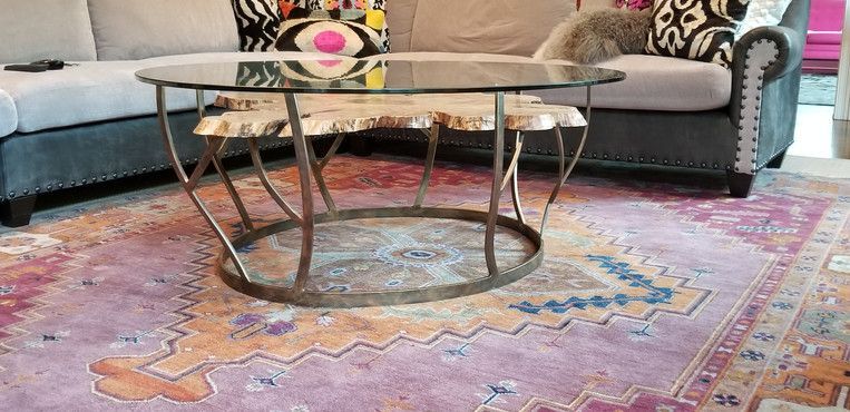 A living room with a couch and a coffee table on a rug.