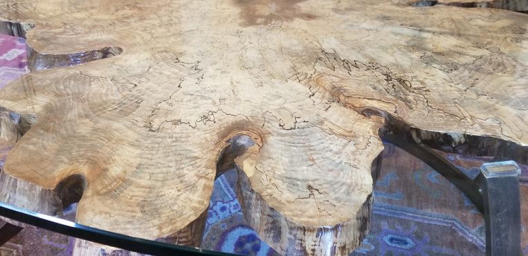 A close up of a wooden table with a glass top.
