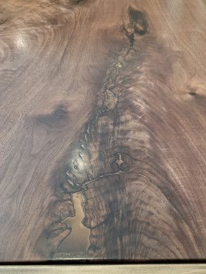 A close up of a piece of wood with a swirl in it.