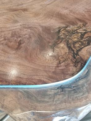A close up of a wooden table with a clear glass top.
