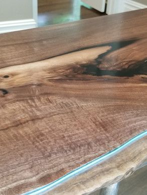A close up of a wooden table with a blue light on it.