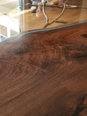 A close up of a wooden table with a glass top.