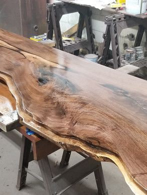 A large piece of wood is sitting on top of a wooden table.