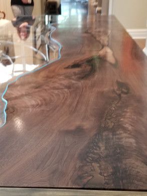 A close up of a wooden table with a glass top.