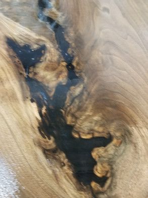 A close up of a piece of wood with a hole in it.